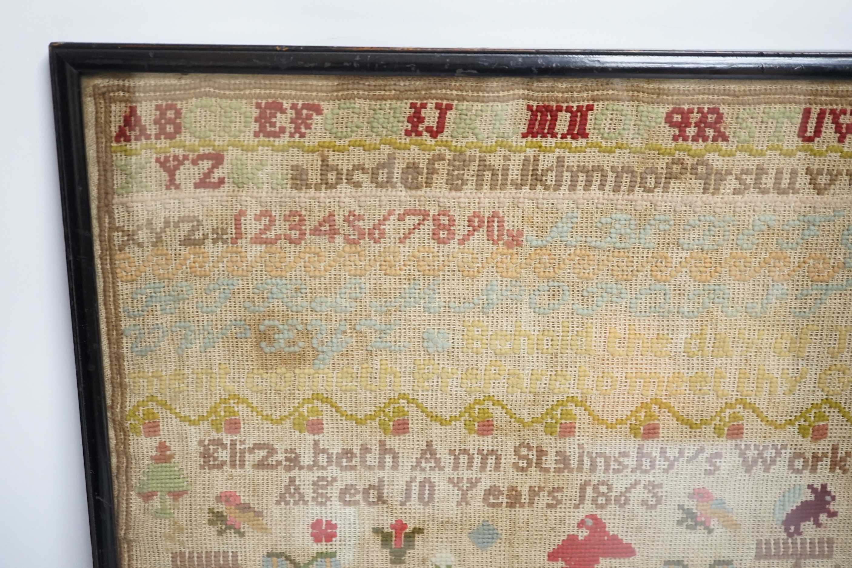 A fine cross stitch needlework sampler, by Sarah Graham, dated Oct 1842, in original frame, 36 x 30cms, and a later wool worked sampler ‘’Elizabeth Ann Stamsby’s Work Aged 10 Years 1865’’ (2)